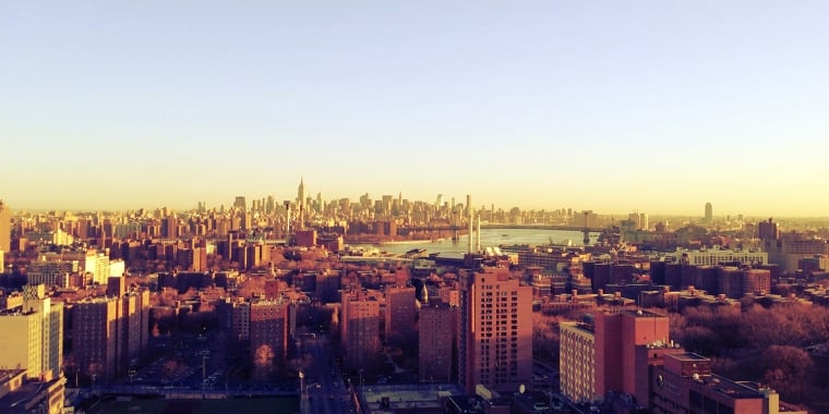 Panoramic view of the New York City skyline taken from Brooklyn at sunrise showing the boroughs of Manhattan, Brooklyn, Queens and The Bronx as well as the East River.